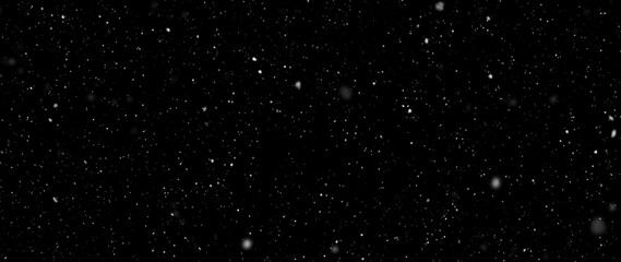 Falling snowflakes out of focus on black background for overlay blending mode. Snowing, snowfall,...