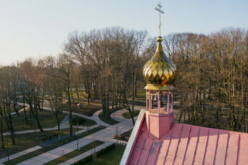 All Russian Saints Orthodox Church in Klaipeda stands quietly in spring light, its golden dome...