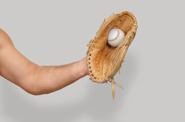 Raised arm holding baseball glove catching ball on neutral background, isolated sports concept.
