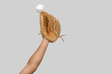 Arm extended with baseball glove ready to intercept moving ball, illustrating precision, reaction.