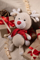Cute Handmade Reindeer Surrounded by Christmas Gifts – Festive Holiday Scene Full of Warmth and Joy