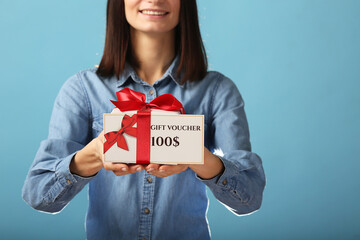 Young excited woman wear pajamas jam sleep eye mask rest relaxing at home point index finger on gift voucher flyer mock up isolated on pastel blue background studio. Good mood night bedtime concept