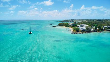 A stunning aerial view of the Mauritius landscape featuring panoramic perspectives of crystal-clear turquoise waters, tropical coastline, and lush island scenery