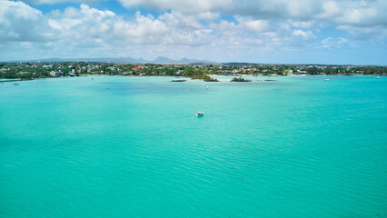 A stunning aerial view of the Mauritius landscape featuring panoramic perspectives of crystal-clear turquoise waters, tropical coastline, and lush island scenery