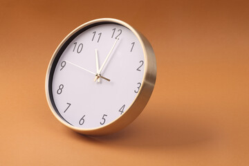 Close-up of a wall clock. The concept of time and work time is valuable for life, Alarm clock stopped. photo in a coloured background