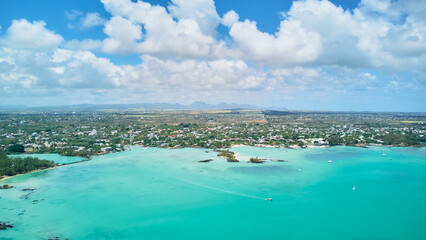 A stunning aerial view of the Mauritius landscape featuring panoramic perspectives of crystal-clear turquoise waters, tropical coastline, and lush island scenery