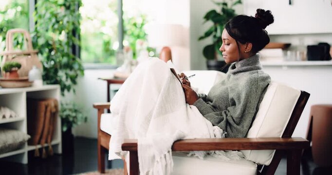 Diary, ideas and writing with woman on sofa in living room of home for reflection or memories. Break, pen and thinking with person journaling in apartment for personal growth, planning or vision