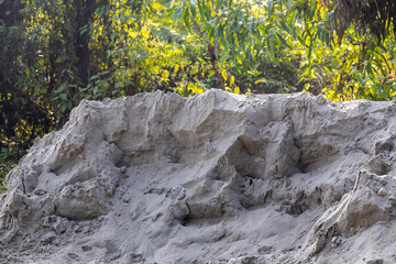 A huge, freshly deposited pile of fine sand aggregate material, likely awaiting transport for construction projects, building supply, or civil engineering site development.