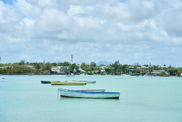 A beautiful idyllic seascape of Mauritius showcasing crystal-clear turquoise waters, gentle waves, and a serene tropical atmosphere. The scene reflects the island&rsquo;s natural beauty, calm ocean tones
