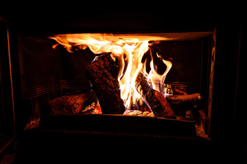 Fireplace with log fire in living room, cozy and warm home	
