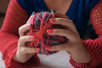 Close-up hands of woman holding colorful yarn ball