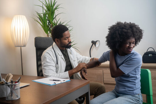 A Modern rehabilitation physiotherapy worker with woman client - Powered by Adobe