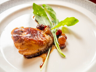 Foie gras, goose liver, grilled with sauce on white dish served in French style in luxury restaurant