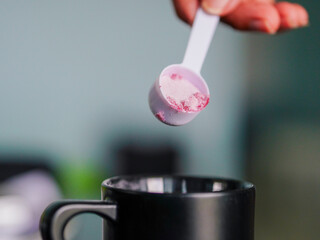 Lifestyle Health care. Hand person scooping collagen powder. Collagen, which contains vitamins, helps nourish, anti age, nutrition and restore the body's deterioration. Healthy snacks morning routine 