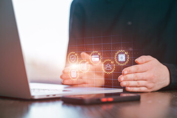 Digital technology supports modern work processes with hands showing data symbols near a laptop and a smartphone on a desk