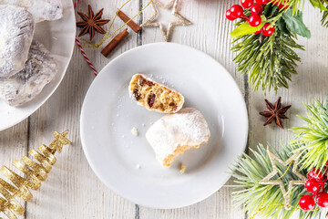 Homemade Christmas stollen bites, miniature, bite-sized versions of traditional Christmas fruit cake bread, chocolate and vanilla stollen cookies biscuits with dried fruits, nuts, marzipan, spices