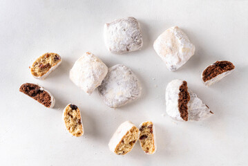 Homemade Christmas stollen bites, miniature, bite-sized versions of traditional Christmas fruit cake bread, chocolate and vanilla stollen cookies biscuits with dried fruits, nuts, marzipan, spices