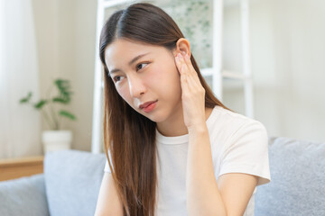 Tinnitus concept, sick asian young woman, girl have ear pain or earache, hand touch plug ear,...