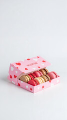 Box of macarons in pink Valentine packaging with heart patterns  
