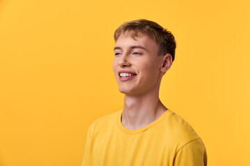 Smile, happy man in a yellow shirt against a vivid yellow background, casual vibe, positive energy, clean studio lighting highlighting warmth and confident expression