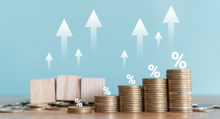 Stacked coins with wooden blocks with world currency symbols representing financial growth, exchange rates, investment, foreign exchange trading and international economy concept.