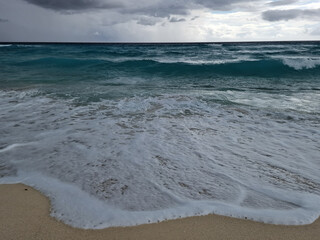 Turquoise Caribbean Waves Crashing on White Sand Beach with Foamy Seawater