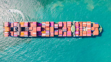 A container ship, fully loaded with goods, sails out to sea, delivering products to various locations around the world.