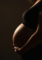 pregnant woman on black background