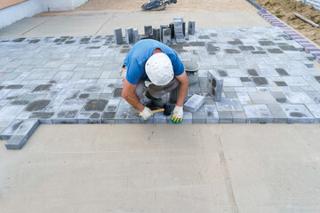 a worker lays paving slabs general plan