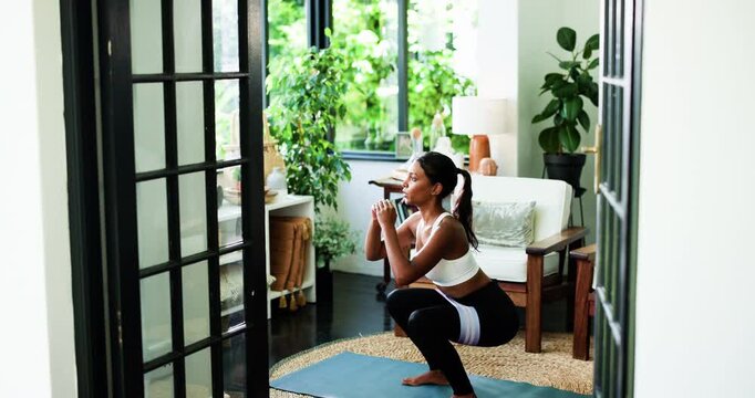 Fitness, squat and woman in home for exercise, wellness or training with resistance band. Health, living room and female person with workout for core strength, leg muscles or toning glutes in house.