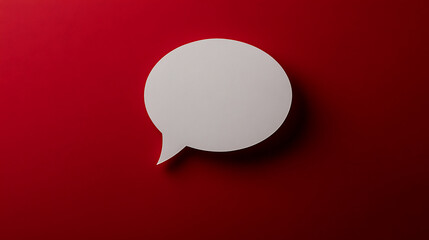 A white speech bubble hovers on a bold red background, symbolizing communication and conversation. The clean, minimalist design creates a modern and engaging visual with a playful touch.
