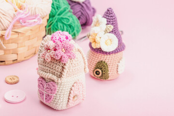 Handmade spring decor concept. Creative crocheting, house figurines, traditional flowers and stuff