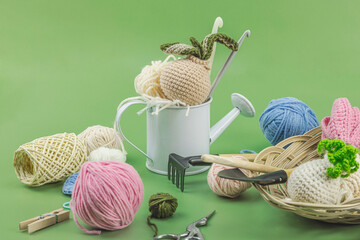 Spring planting and gardening concept. Handmade flowers with bulbs, mini tools, watering can, buckets