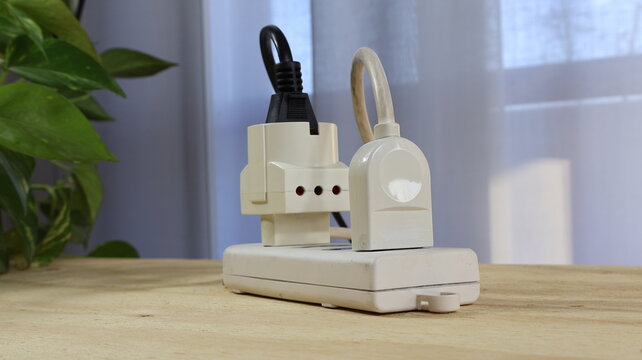 Power cords plugged into an electric power strip schuko type, with double socket.