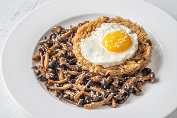 Savory fried rice topped with umami Shimeji mushrooms and golden sunny egg