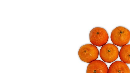 Tangerine mandarin fruits forming corner pattern on white