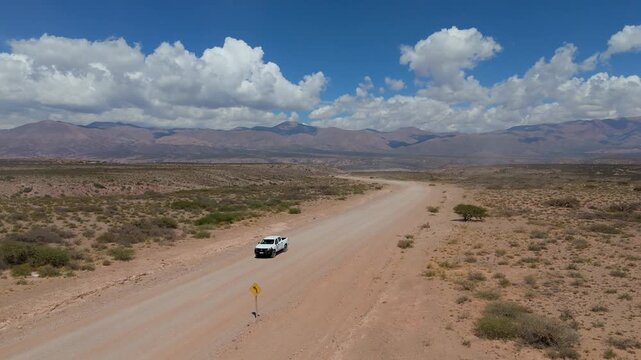 Aerial shot taken by drone of a 4x4 truck on a dirt road in northwestern Argentina, in the province of Jujuy.