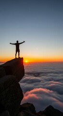Fototapeta premium Silhouette of a person with open arms standing on mountain cliff above clouds during vibrant sunset. concept of freedom, adventure, breathtaking scenery., vertical
