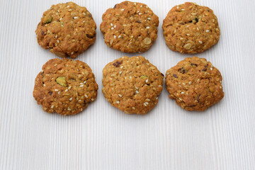 Homemade cookies with oatmeal, several kinds of seeds and nuts, copy space for text