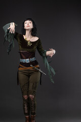 Brunette elf warrior wearing ethereal blouse and practical leather dagger belt