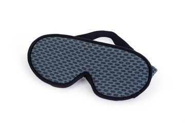 a padded sleep mask resting on a white background