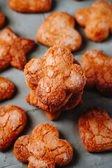 a stack of coquetes de sagi with scattered cookies