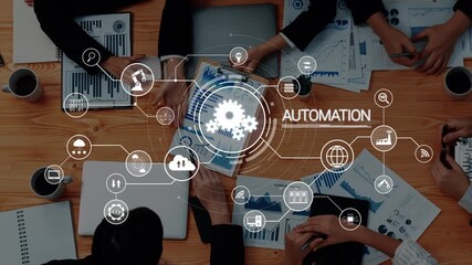 A diverse business team collaborates on automation strategies using digital charts and infographics while engaging in a productive meeting environment. Raster - Powered by Adobe