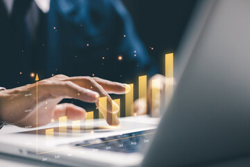 Business growth concept showing a user working on a laptop with rising bar charts, symbolizing financial improvement, performance tracking, and long term success in digital business operations.