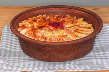 Cottage cheese casserole with apple slices on top, front view