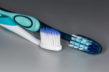 Two toothbrushes with soft and hard bristles, close-up