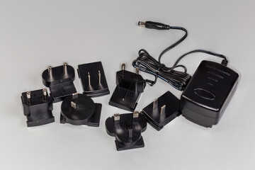 Power unit with adapters under regional AC power supply standards