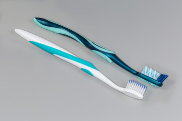 Two toothbrushes with soft and hard bristles, close-up