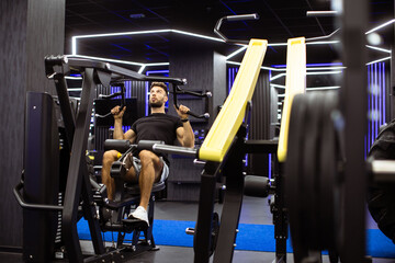 Man training on lat pulldown machine in modern gym during workout session