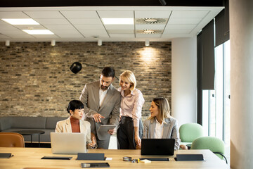 Team collaboration in modern office during business meeting with laptops and tablets